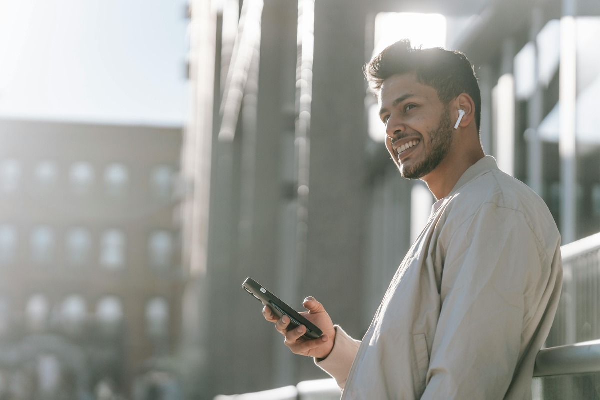 Man with phone smiling